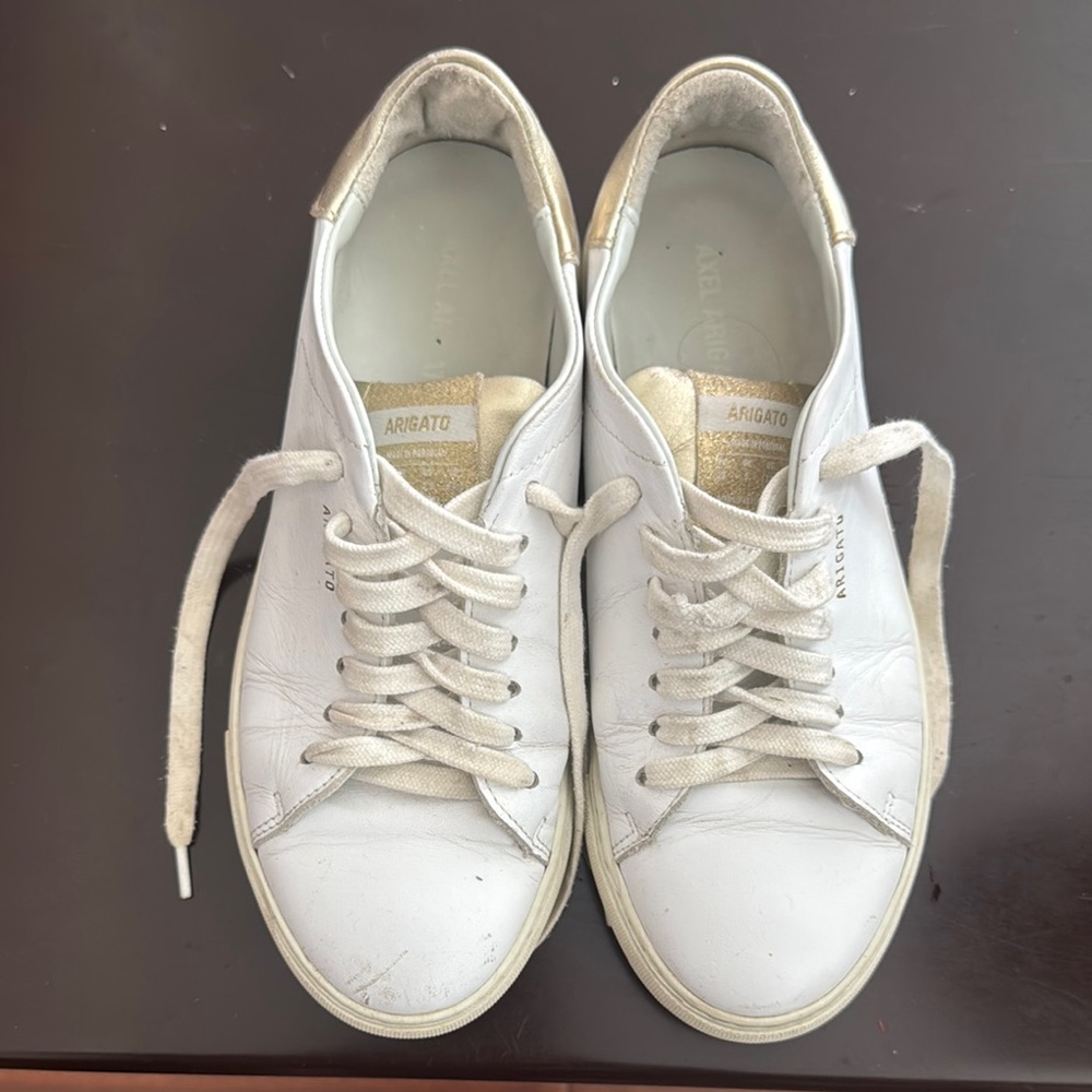 Axel Arigato White and Gold Sneakers
